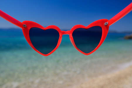 View through sunglasses to beach on sunny day. Close up.の写真素材