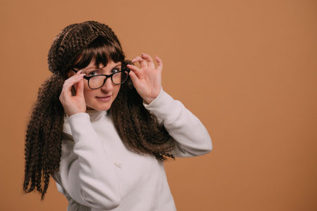 Young joyful woman in glasses looks at camera. Close up portrait.