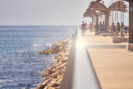 ALICANTE, SPAIN, CIRCA JUNE 2018 People walking on a pier.のeditorial素材