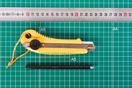 cutter, ruller and pencil on a green cutting matの写真素材