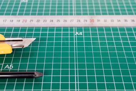 cutter, ruller and pencil on a green cutting matの写真素材