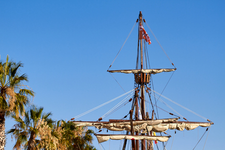 Mast of the spanish replica of the Nao de Santa Maria with some palm treesの写真素材