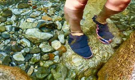 Girl foot on a riverの写真素材