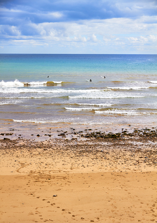 message in the sand and some people surfingの写真素材