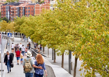 BILBAO, SPAIN, CIRCA AUGUST 2018, people walking next to the riverのeditorial素材