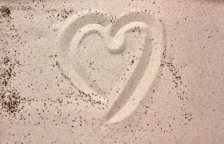 heart drawing in the sandの写真素材