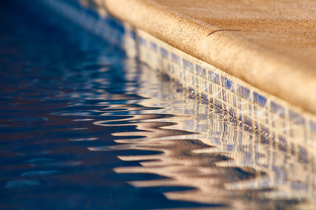 poolside with clear blue waterの写真素材