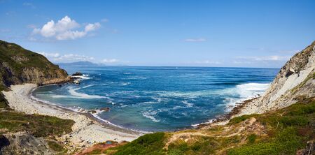 Blue Bizkaia beach in basque country with some surfersの写真素材