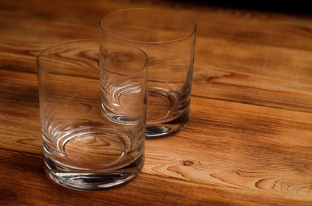 Glasses for whiskey on a wooden tableの写真素材