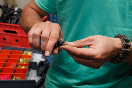 The master in the service removes insulation from the wire.の写真素材