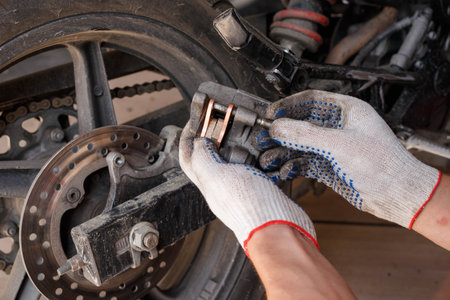 The process of replacing brake pads on a motorcycle.