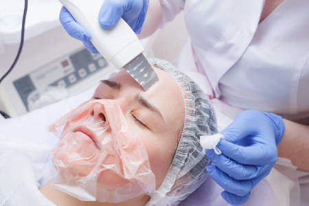 woman getting ultrasound skin cleaning at beauty salon