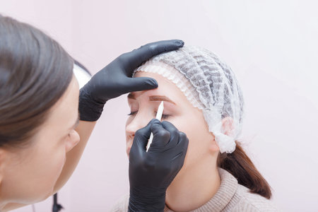 The wizard creates the contour of the clients eyebrows before the procedure.の写真素材