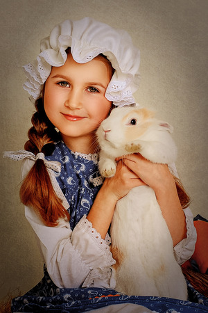 Girl playing with Easter bunnyの写真素材
