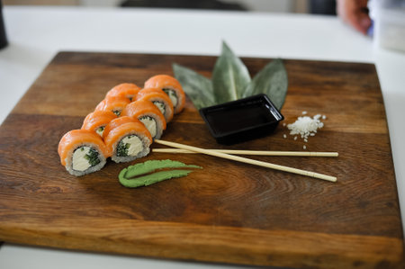 sushi roll with salmon, avocado, cucumber and wasabi on wooden boardの写真素材