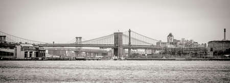 Panoramic View of Brooklyn Bridge Crossing East River. Black and White Perspective. Manhattan, New York City, USAのeditorial素材