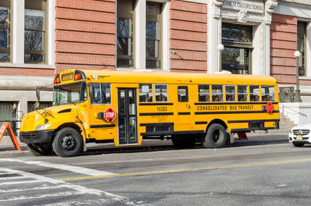 Classic Yellow American School Bus Parked Somewhere in Midtown Manhattan, New York City, USAのeditorial素材