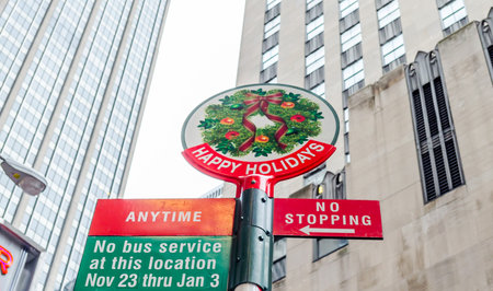 Colorfull Happy Holidays Traffic Sign in Manhattan, New York City, USA. Low Angle View Photo. Skyscrapers in Backgroundの写真素材
