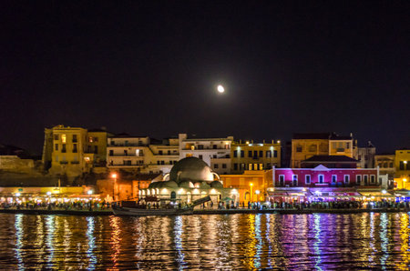 Picturesque Old Venetian Harbor in Chania, Crete Island, Greece at Night with Illuminated Buildings. Picturesque Old Venetian Harbor with Illuminated Buildings, Cafes, Bars.の写真素材