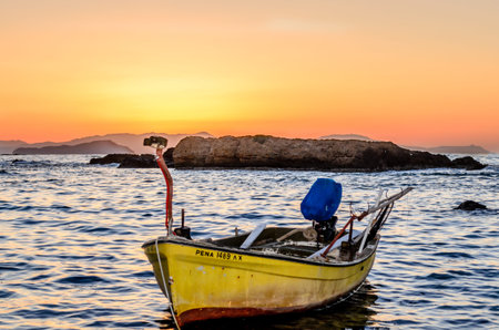 Traditional Yellow Fishing Boat in the Greek Island of Crete at Sunset. Summer Season in Greece....