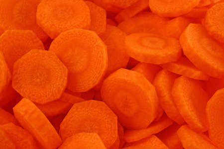background from pieces of fresh diced carrotsの写真素材