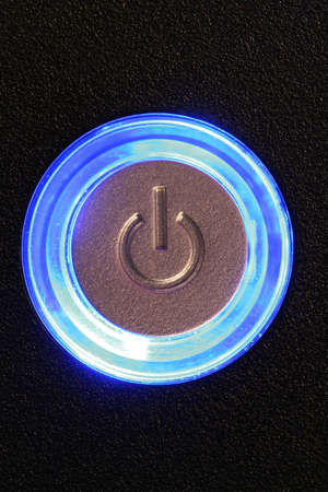 blue glowing power button - computer or any device is onの写真素材