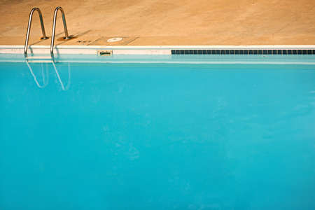 plain simple background of an empty blue swimming pool with plenty of copyspaceの写真素材