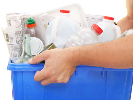 close view of male hands holding a recycle bin full of recyclablesの写真素材
