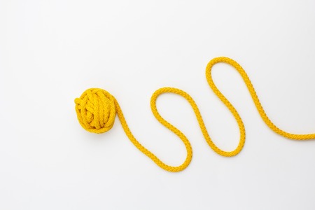close up of yellow knitting on white backgroundの写真素材