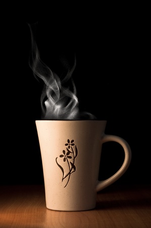 cup of hot tea or coffee over black backgroundの写真素材