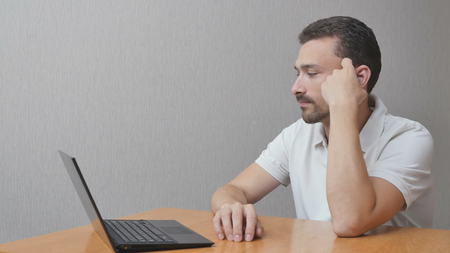 The man is waiting for an answer. person in anticipation about notebook. Disgruntled workerの写真素材