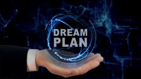 Painted hand shows concept hologram Dream plan on his hand. Drawn man in business suit with future technology screen and modern cosmic backgroundの写真素材