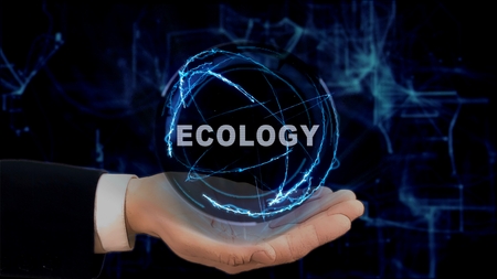 Painted hand shows concept hologram Ecology on his hand. Drawn man in business suit with future technology screen and modern cosmic backgroundの写真素材