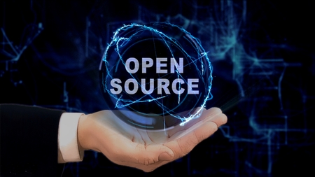 Painted hand shows concept hologram Open source on his hand. Drawn man in business suit with future technology screen and modern cosmic backgroundの写真素材