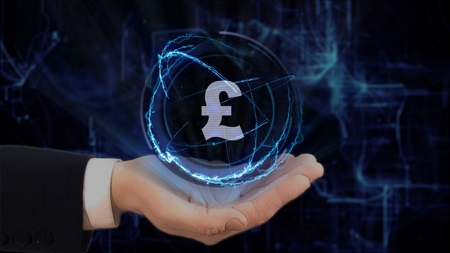 Painted hand shows concept hologram Sign British Pound on his hand. Drawn man in business suit with future technology screen and modern cosmic backgroundの写真素材