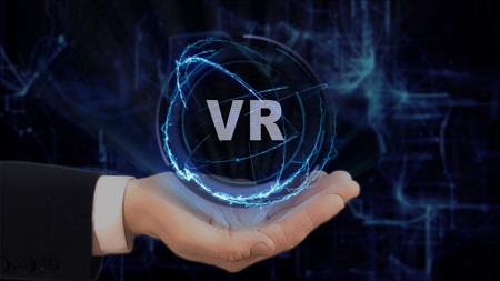 Painted hand shows concept hologram VR on his hand. Drawn man in business suit with future technology screen and modern cosmic backgroundの写真素材
