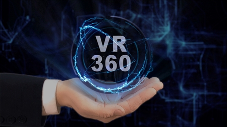 Painted hand shows concept hologram VR 360 on his hand. Drawn man in business suit with future technology screen and modern cosmic backgroundの写真素材