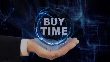 Painted hand shows concept hologram Buy time on his hand. Drawn man in business suit with future technology screen and modern cosmic backgroundの写真素材