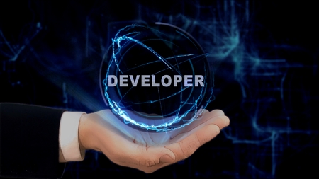 Painted hand shows concept hologram Developer on his hand. Drawn man in business suit with future technology screen and modern cosmic backgroundの写真素材