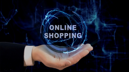 Painted hand shows concept hologram Online shopping on his hand. Drawn man in business suit with future technology screen and modern cosmic backgroundの写真素材