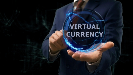 Businessman shows concept hologram Virtual currency on his hand. Man in business suit with future technology screen and modern cosmic backgroundの写真素材