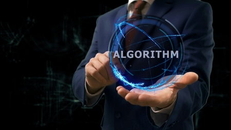 Businessman shows concept hologram Algorithm on his hand. Man in business suit with future technology screen and modern cosmic backgroundの写真素材