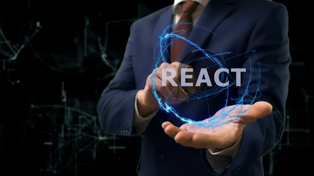 Businessman shows concept hologram React on his hand. Man in business suit with future technology screen and modern cosmic backgroundの写真素材