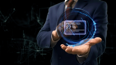 Businessman shows concept hologram Percend Protected on his hand. Man in business suit with future technology screen and modern cosmic backgroundの写真素材
