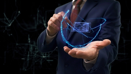 Businessman shows concept hologram 3d CPU on his hand. Man in business suit with future technology screen and modern cosmic backgroundの写真素材