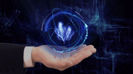 Painted hand shows concept hologram 3d tree on his hand. Drawn man in business suit with future technology screen and modern cosmic backgroundの写真素材