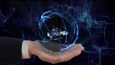 Painted hand shows concept hologram 3d truck on his hand. Drawn man in business suit with future technology screen and modern cosmic backgroundの写真素材