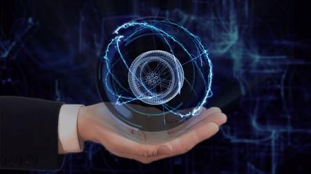 Painted hand shows concept hologram 3d wheel on his hand. Drawn man in business suit with future technology screen and modern cosmic backgroundの写真素材