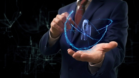 Businessman shows concept hologram 3d pocket camera on his hand. Man in business suit with future technology screen and modern cosmic backgroundの写真素材