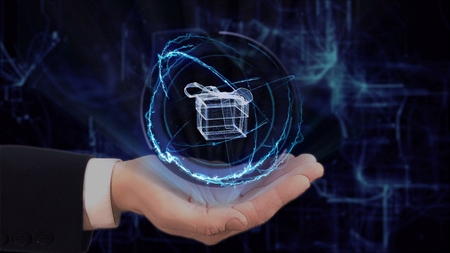 Painted hand shows concept hologram 3d gift box on his hand. Drawn man in business suit with future technology screen and modern cosmic backgroundの写真素材